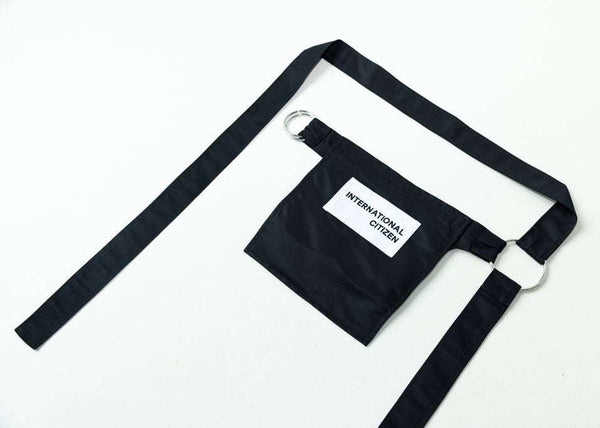 INTERNATIONAL CITIZEN.  Style: The M24 Cross Body Bag features a zipper welt pocket and patch pocket flap with adjustable ring straps. Unisex Item. Made of Italian post-consumer recycled Nylon, Obsidian Black. Spiritually Infused, Sustainable Luxury Fashion in Berlin. Back photo.