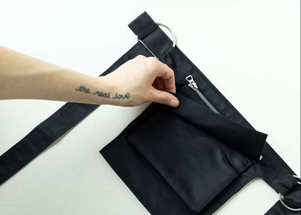 INTERNATIONAL CITIZEN.  Style: The M24 Cross Body Bag features a zipper welt pocket and patch pocket flap. Unisex Item. Made of Italian post-consumer recycled Nylon, Obsidian Black. Spiritually Infused, Sustainable Luxury Fashion in Berlin. Pocket photo.