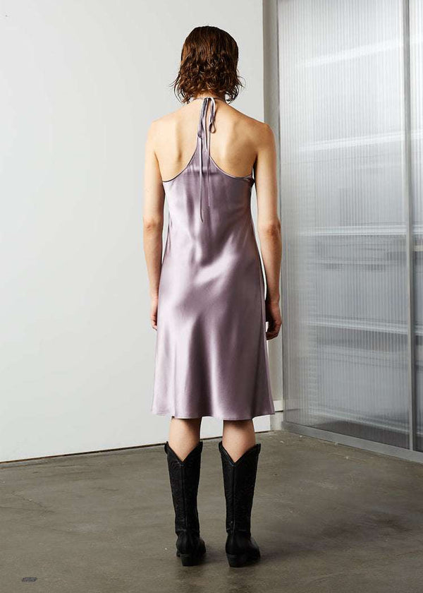 INTERNATIONAL CITIZEN.  Style: The Short Chakra Slip Dress is cut on the bias. The neckline has long straps that tie at the back neck. Made of Organic Silk, Fluorite Purple. Spiritually Infused, Sustainable Luxury Fashion in Berlin. Back photo.