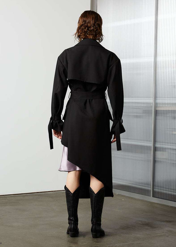 INTERNATIONAL CITIZEN.  Style: The Eclipse Jacket. A unisex, asymmetrical along the hemline and oversized with soft shoulder pads for collapsed structure. Back view. Made of Italian RWS Wool, Obsidian Black. Spiritually Infused, Sustainable Luxury Fashion in Berlin.