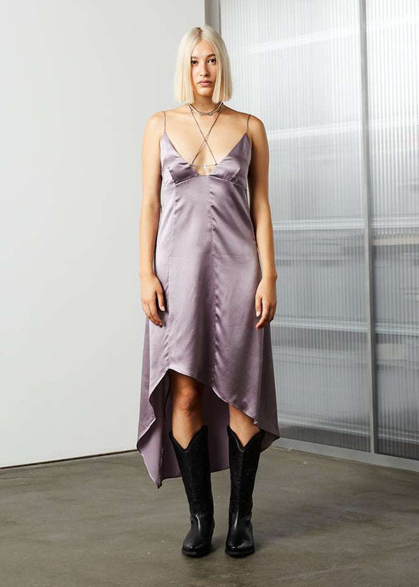 INTERNATIONAL CITIZEN.  Style: Short Chakra Slip Dress. Front view. The dress is cut on the bias and features hand sewn crystals down the front to represent the 7-Chakras. The neckline has long straps that tie at the back neck. Made of Organic Silk, Fluorite Purple. Spiritually Infused, Sustainable Luxury Fashion in Berlin.