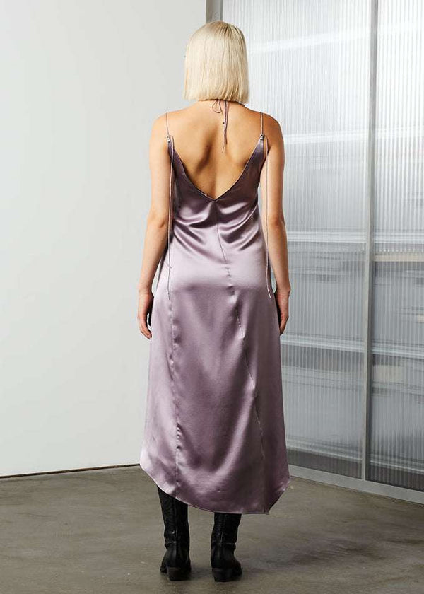 INTERNATIONAL CITIZEN.  Style: Short Chakra Slip Dress. Back body view. The dress is cut on the bias with long straps that tie at the back neck. Made of Organic Silk, Fluorite Purple. Spiritually Infused, Sustainable Luxury Fashion in Berlin.