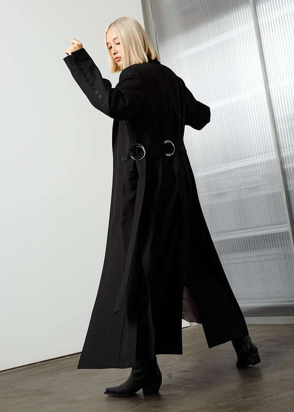 INTERNATIONAL CITIZEN.  Style: The M23 Duster Coat. Unisex Item. Side back photo. Made of Italian Wool RWS, Obsidian Black. Spiritually Infused, Sustainable Luxury Fashion in Berlin.
