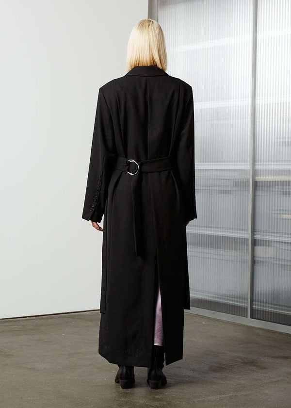 INTERNATIONAL CITIZEN.  Style: The M23 Duster Coat features high slits at the sides and back. Unisex Item. Full back photo. Made of Italian Wool RWS, Obsidian Black. Spiritually Infused, Sustainable Luxury Fashion in Berlin.