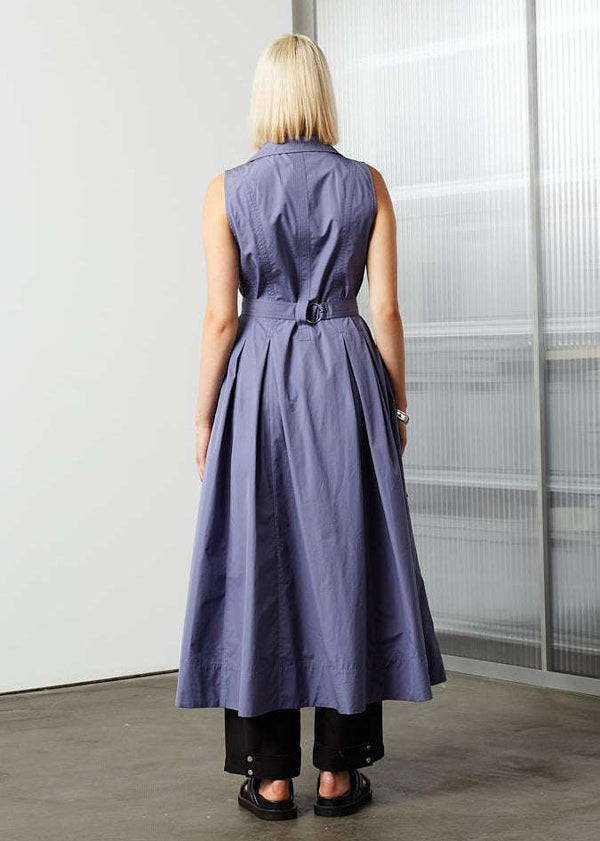 INTERNATIONAL CITIZEN.  Style: Button Dress. Back body view. A Button Dress with princess seams that open to box pleats below the hips. Detachable belt with silver ring details for closure. The dress is made of Italian organic Cotton in Dreamstate Purple. Spiritually Infused, Sustainable Luxury Fashion in Berlin.
