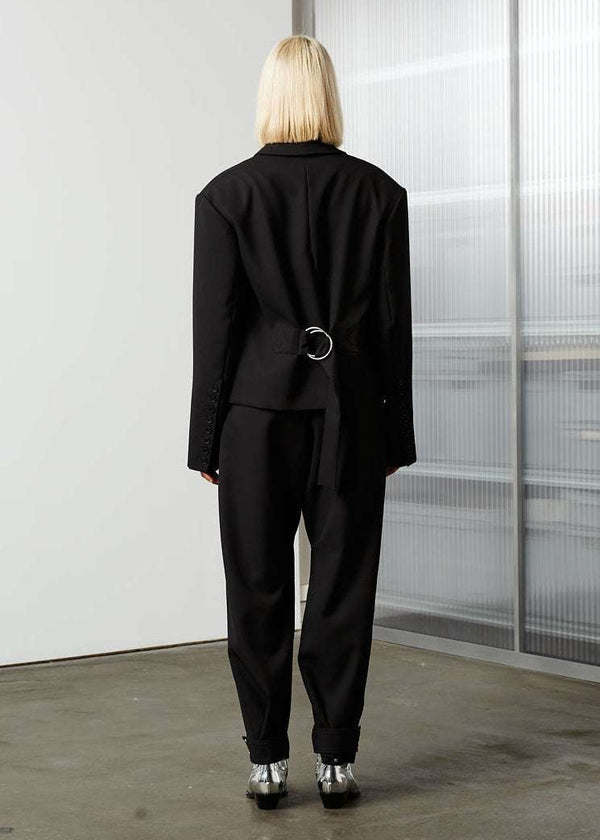 INTERNATIONAL CITIZEN.  Style: The Oversized Men’s Jacket features classic mens tailoring details within the inner construction with an oversized shape. Unisex item. Made of Italian Wool RWS, Obsidian Black. Spiritually Infused, Sustainable Luxury Fashion in Berlin. Full body back photo.