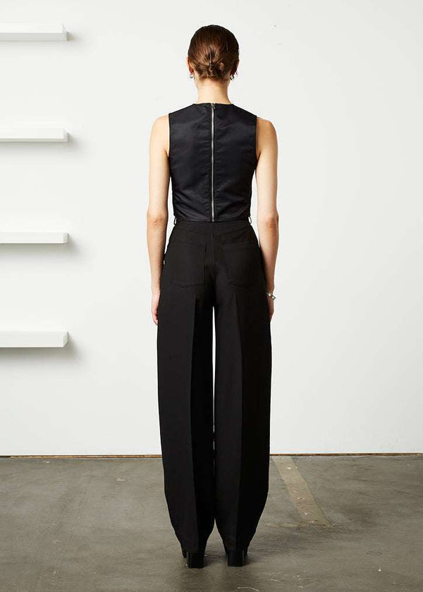 INTERNATIONAL CITIZEN.  Style: The Ribcage Trouser is a high waisted pant, with a perfectly tapered pin-tuck leg that falls over the shoe, featuring denim style detailing in the back body. Made of Italian Wool RWS, Obsidian Black. Spiritually Infused, Sustainable Luxury Fashion in Berlin. Full back photo.