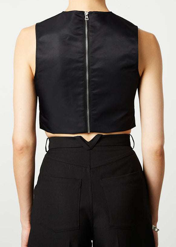 INTERNATIONAL CITIZEN.  Style: The Seven Chakra Top is an unlined shell top with an exposed silver metal zipper closure at the back. It features metal eyelets down the front and chakra crystals looped with a braided cord. Made of Italian post-consumer recycled Nylon, Obsidian Black. Spiritually Infused, Sustainable Luxury Fashion in Berlin. Back photo.
