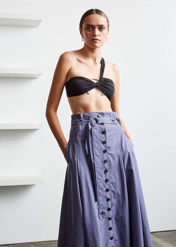 INTERNATIONAL CITIZEN.  Style: Button Skirt. A Button Skirt with box pleats below the hips. Detachable belt with silver ring details for closure. The skirt is made of Italian organic Cotton in Dreamstate Purple. Spiritually Infused, Sustainable Luxury Fashion in Berlin.