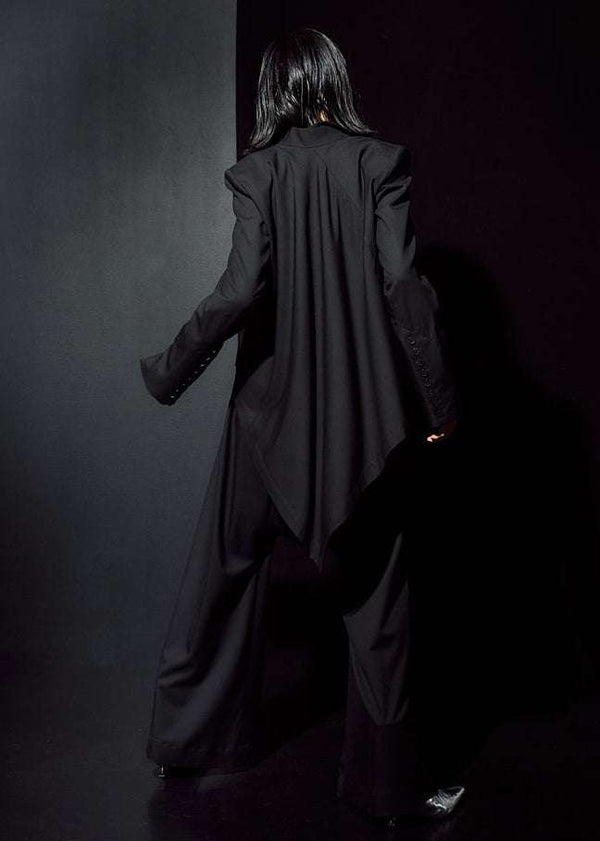 INTERNATIONAL CITIZEN.  Style: The Ascension Jacket. Full body back view. Style has a tailored structured body, an asymmetrical cascading back body on the bias. The jacket is made of Italian RWS Wool in Obsidian Black. Spiritually Infused, Sustainable Luxury Fashion in Berlin.