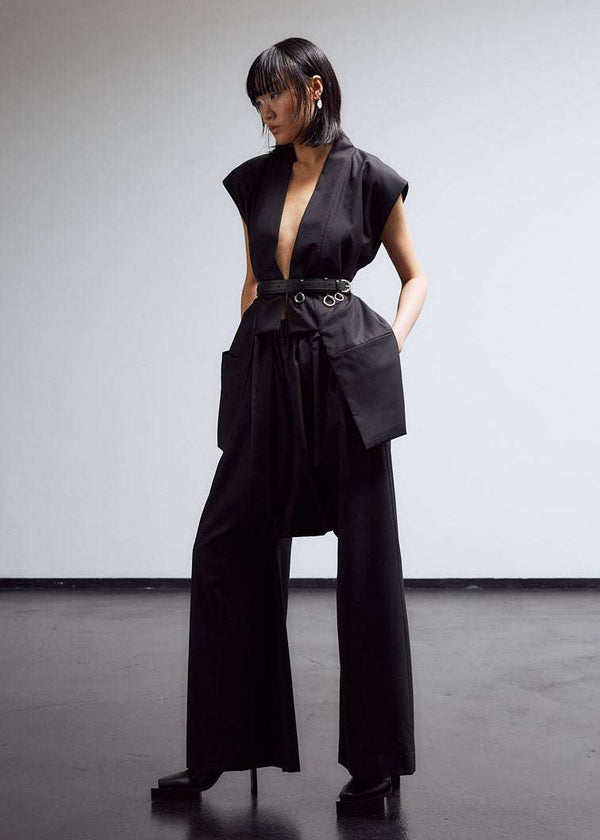 INTERNATIONAL CITIZEN.  Style: The Lanna Pant have a dropped crotch and inseam pockets. Unisex Item. Fashion styling photo. Made of Italian Wool, certified (RWS) Responsible Wool Standard, Obsidian Black. Spiritually Infused, Sustainable Luxury Fashion in Berlin.
