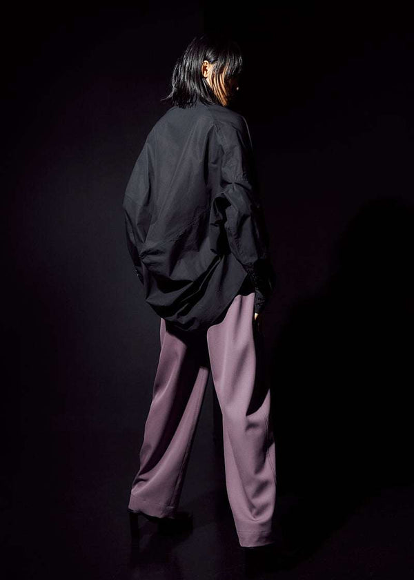 INTERNATIONAL CITIZEN.  Style: The Cubism Shirt is a 3-dimensional cube tilted on its axes to create a dramatic drape in the back body. Unisex Item. Full body back view. Made of Italian Organic Cotton, Obsidian Black. Spiritually Infused, Sustainable Luxury Fashion in Berlin.