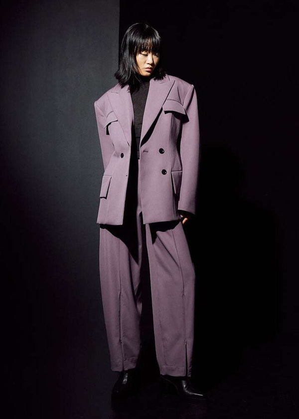 INTERNATIONAL CITIZEN.  Style: The Hourglass Jacket is named after its perfected silhouette, shaped with a nipped waist. It is double breasted but worn open here. Unisex Item. Made of Italian Wool, certified RWS, Amethyst Purple. Spiritually Infused, Sustainable Luxury Fashion in Berlin.