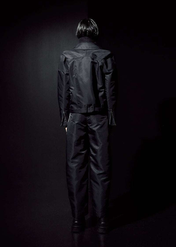 INTERNATIONAL CITIZEN.  Style: The M23 Moto Jacket has classic moto detailing and an innovative drape at the back shoulder creating a soft strength in the silhouette. Unisex Item. Full back photo. Made of Italian post-consumer recycled Nylon, Obsidian Black. Spiritually Infused, Sustainable Luxury Fashion in Berlin.