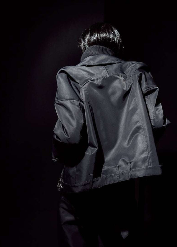 INTERNATIONAL CITIZEN.  Style: The M23 Moto Jacket has classic moto detailing and an innovative drape at the back shoulder creating a soft strength in the silhouette. Unisex Item. Back body. Made of Italian post-consumer recycled Nylon, Obsidian Black. Spiritually Infused, Sustainable Luxury Fashion in Berlin.