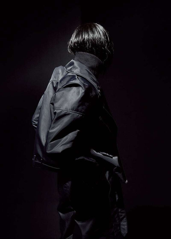 INTERNATIONAL CITIZEN.  Style: The M23 Moto Jacket has classic moto detailing. Side back photo. Made of Italian post-consumer recycled Nylon, Obsidian Black. Spiritually Infused, Sustainable Luxury Fashion in Berlin.