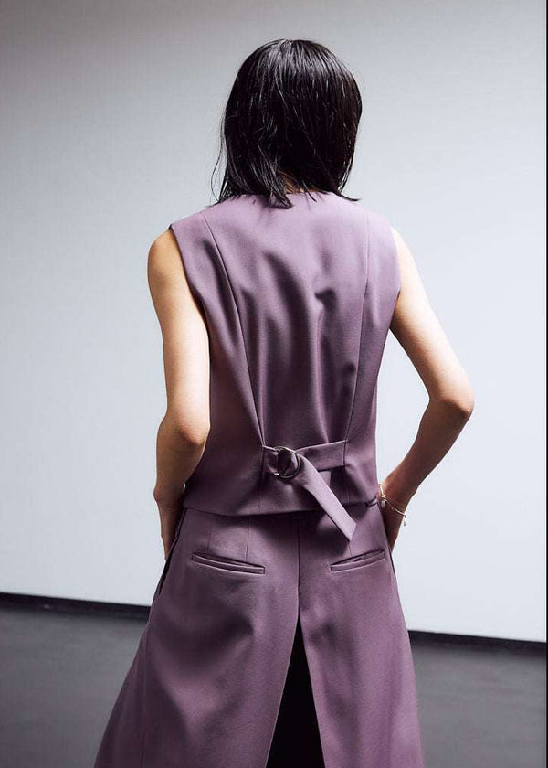 INTERNATIONAL CITIZEN.  Style: The Tarot Vest is a riff on classic vest detailing with exposed hem pocket bags and 7-Chakra button closure down the front. Made of Italian Wool RWS, Obsidian Black. Spiritually Infused, Sustainable Luxury Fashion in Berlin. Side back photo.