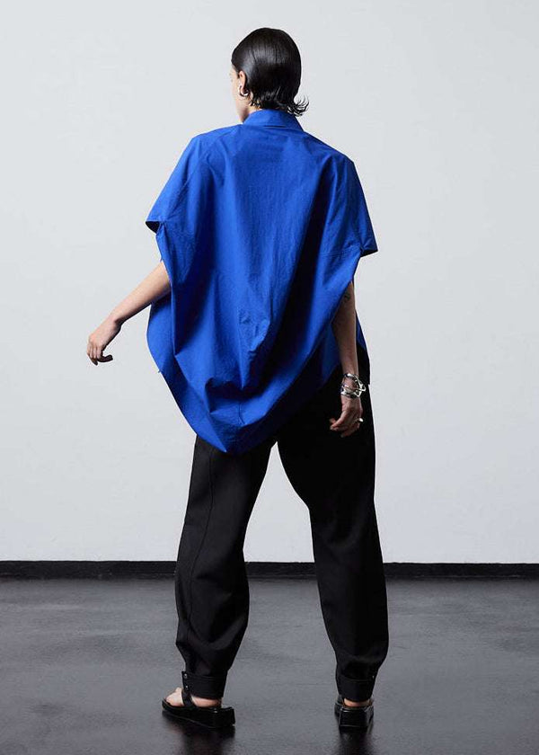 INTERNATIONAL CITIZEN.  Style: The Cubism Shirt is a 3-dimensional cube tilted on its axes to create a dramatic drape in the back body. Unisex Item. Full body back view. Made of Italian Organic Cotton, Lapis Lazuli Blue. Spiritually Infused, Sustainable Luxury Fashion in Berlin.