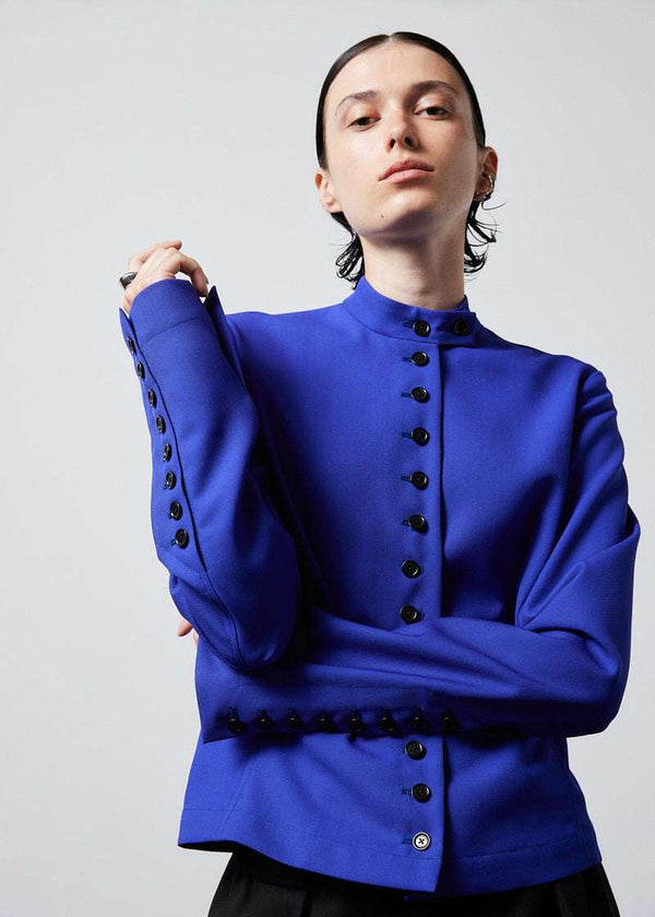 INTERNATIONAL CITIZEN.  Style: The Lunar Shacket is a slim jacket that wears like a shirt. It is lined with horn buttons. Close up of the buttons. Made of Italian Wool RWS, Lapis Lazuli Blue. Spiritually Infused, Sustainable Luxury Fashion in Berlin.