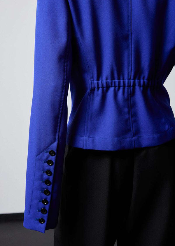 INTERNATIONAL CITIZEN.  Style: The Lunar Shacket is a slim jacket that has a bias under sleeve for a slim fit, extra-long sleeves, and an elastic back waist. Close up back body photo. Made of Italian Wool RWS, Lapis Lazuli Blue. Spiritually Infused, Sustainable Luxury Fashion in Berlin.