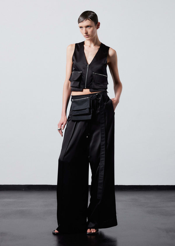 INTERNATIONAL CITIZEN.  Style: The Mini Zipper Vest has double pocket detailing with both a patch pocket and zipper welt with exposed pocket bags. Made of Organic Silk, Obsidian Black. Spiritually Infused, Sustainable Luxury Fashion in Berlin. Fully body front photo.