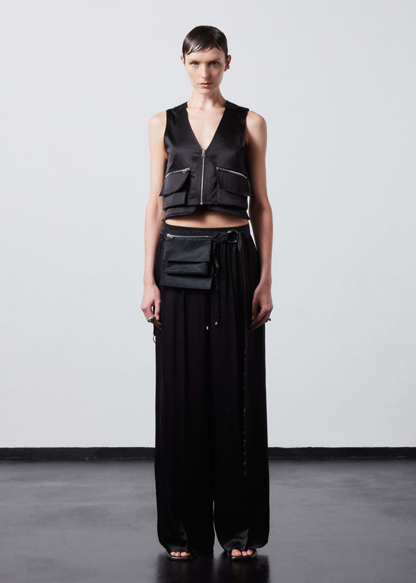 INTERNATIONAL CITIZEN.  Style: The Arcana Pant. Style has a relaxed fit with front pin-tucks and excessive volume eased into the waistband. Unisex Item. The pants are made of Italian organic silk in Obsidian Black. Spiritually Infused, Sustainable Luxury Fashion in Berlin.
