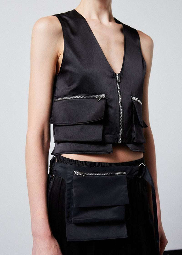 INTERNATIONAL CITIZEN.  Style: The Mini Zipper Vest has double pocket detailing with both a patch pocket and zipper welt with exposed pocket bags. Made of Organic Silk, Obsidian Black. Spiritually Infused, Sustainable Luxury Fashion in Berlin. Close up front photo.