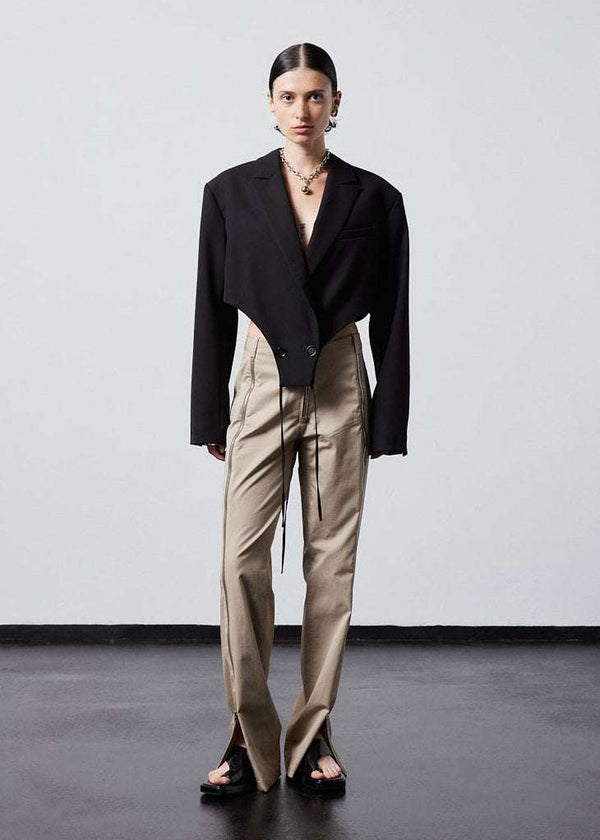 INTERNATIONAL CITIZEN.  Style: The French-Cut Jacket is oversized in the fit with a high french-cut hemline. Full body front photo. Unisex item. Made of Italian Wool, Obsidian Black. Spiritually Infused, Sustainable Luxury Fashion in Berlin.