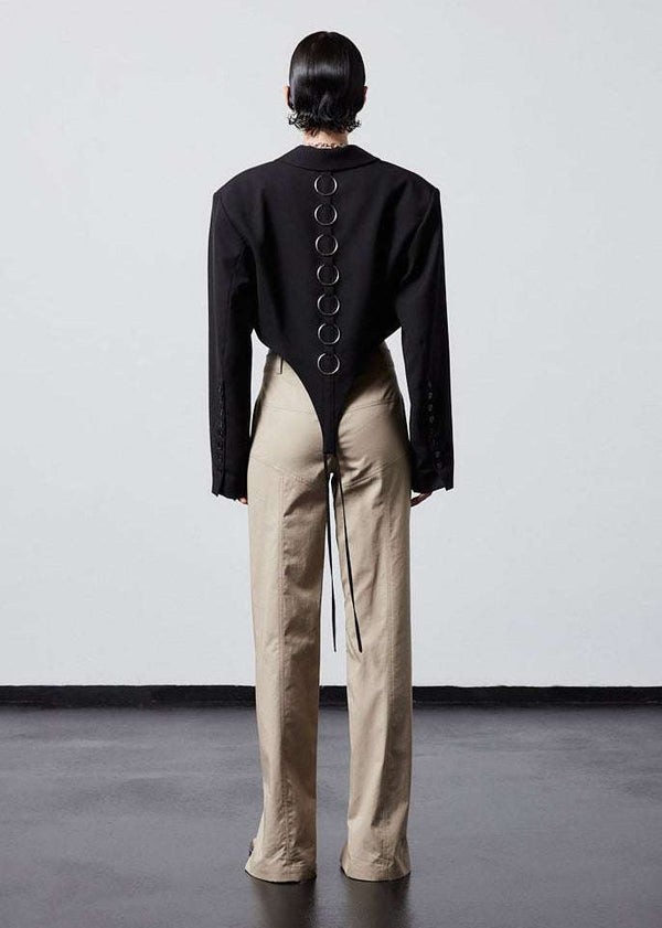 INTERNATIONAL CITIZEN.  Style: The French-Cut Jacket is oversized in the fit with a high french-cut hemline. Full body back photo. Unisex item. Made of Italian Wool, Obsidian Black. Spiritually Infused, Sustainable Luxury Fashion in Berlin.