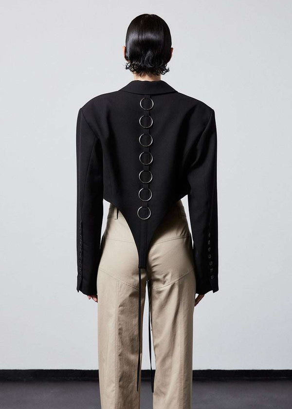 INTERNATIONAL CITIZEN.  Style: The French-Cut Jacket is oversized in the fit with a high french-cut hemline and rings down the center back. Unisex item. Back body photo. Made of Italian Wool, Obsidian Black. Spiritually Infused, Sustainable Luxury Fashion in Berlin.