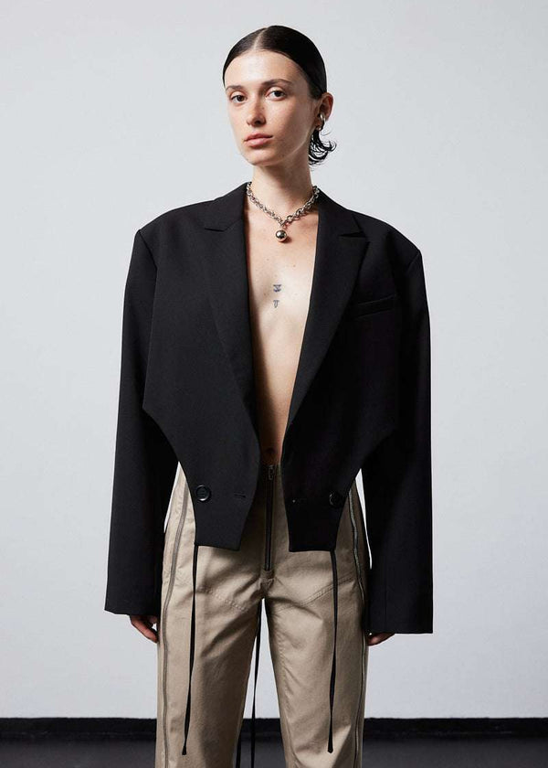 INTERNATIONAL CITIZEN.  Style: The French-Cut Jacket is oversized in the fit with a high french-cut hemline. Unisex item. Made of Italian Wool, Obsidian Black. Spiritually Infused, Sustainable Luxury Fashion in Berlin.