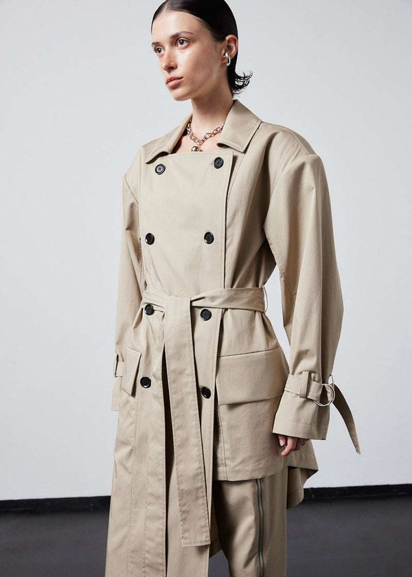 INTERNATIONAL CITIZEN.  Style: The Eclipse Jacket. A unisex, asymmetrical along the hemline and oversized with soft shoulder pads for collapsed structure. Close up front view. Made of Italian Organic Cotton, Dune. Spiritually Infused, Sustainable Luxury Fashion in Berlin.