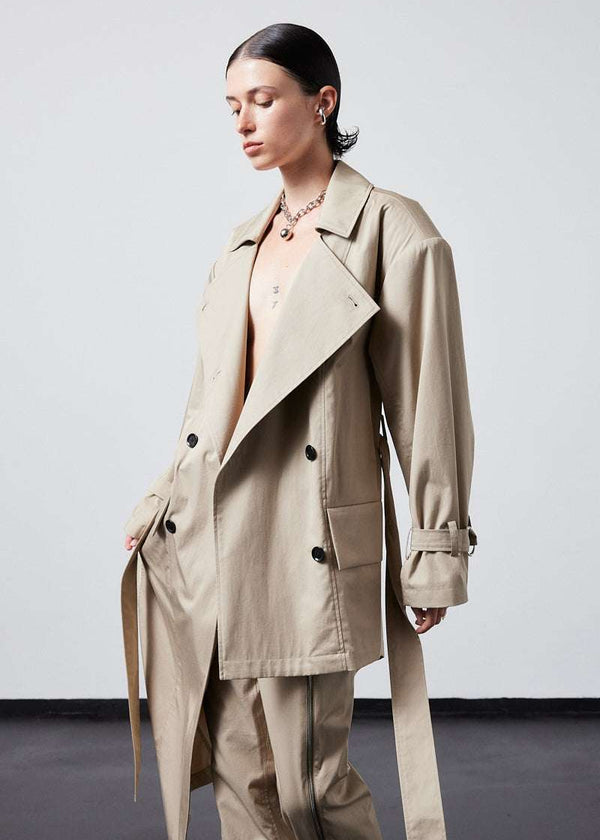 INTERNATIONAL CITIZEN.  Style: The Eclipse Jacket. A unisex, asymmetrical along the hemline and oversized with soft shoulder pads for collapsed structure. Close up side front view worn open. Made of Italian Organic Cotton, Dune. Spiritually Infused, Sustainable Luxury Fashion in Berlin.