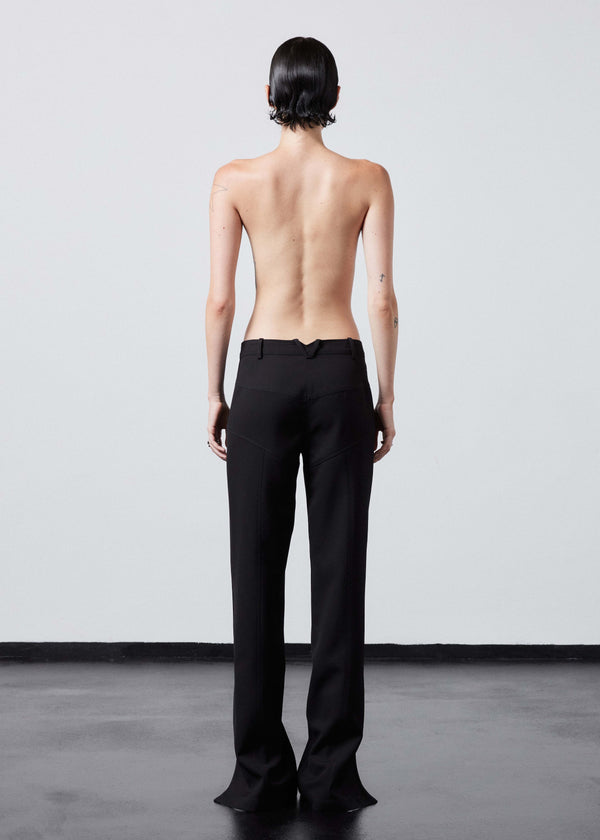 INTERNATIONAL CITIZEN.  Style: The Racer Pants have zippers down the entire front legs from the waistband to the hemline and a fly front zip. Made of Italian Wool RWS, Obsidian Black. Spiritually Infused, Sustainable Luxury Fashion in Berlin. Full back photo.