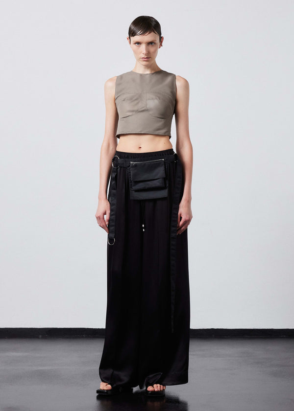 INTERNATIONAL CITIZEN.  Style: The Shell Top is made of water repellent reNylon Gabardine and an exposed metal zipper at the back closure. Made of Italian post-consumer recycled Nylon, Dune. Spiritually Infused, Sustainable Luxury Fashion in Berlin. Full body front photo.