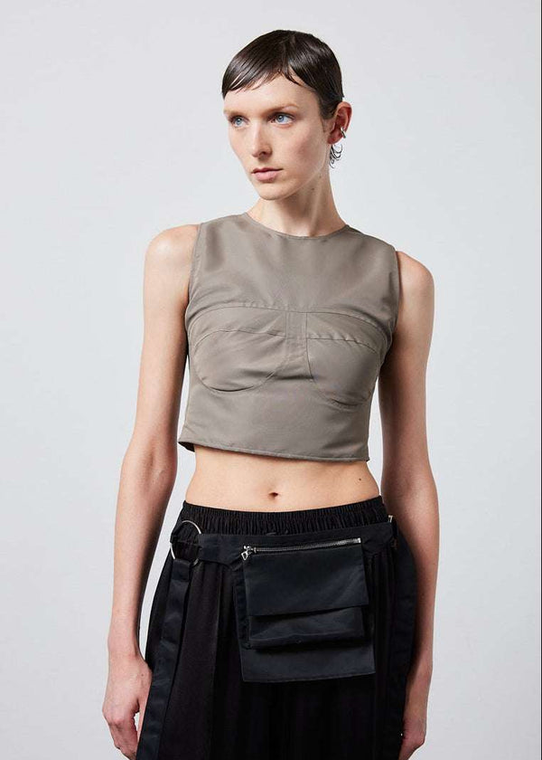 INTERNATIONAL CITIZEN.  Style: The Shell Top is made of water repellent reNylon Gabardine and an exposed metal zipper at the back closure. Made of Italian post-consumer recycled Nylon, Dune. Spiritually Infused, Sustainable Luxury Fashion in Berlin. Front photo.