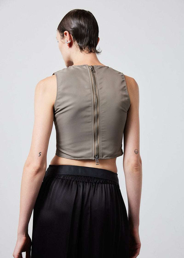 INTERNATIONAL CITIZEN.  Style: The Shell Top is made of water repellent reNylon Gabardine and an exposed metal zipper at the back closure. Made of Italian post-consumer recycled Nylon, Dune. Spiritually Infused, Sustainable Luxury Fashion in Berlin. Back photo.