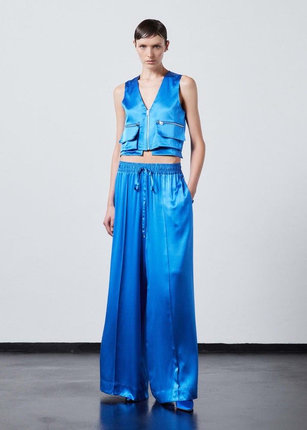 INTERNATIONAL CITIZEN.  Style: The Mini Zipper Vest has double pocket detailing with both a patch pocket and zipper welt with exposed pocket bags. Made of Organic Silk, Azurite Blue. Spiritually Infused, Sustainable Luxury Fashion in Berlin.
Full body view.
