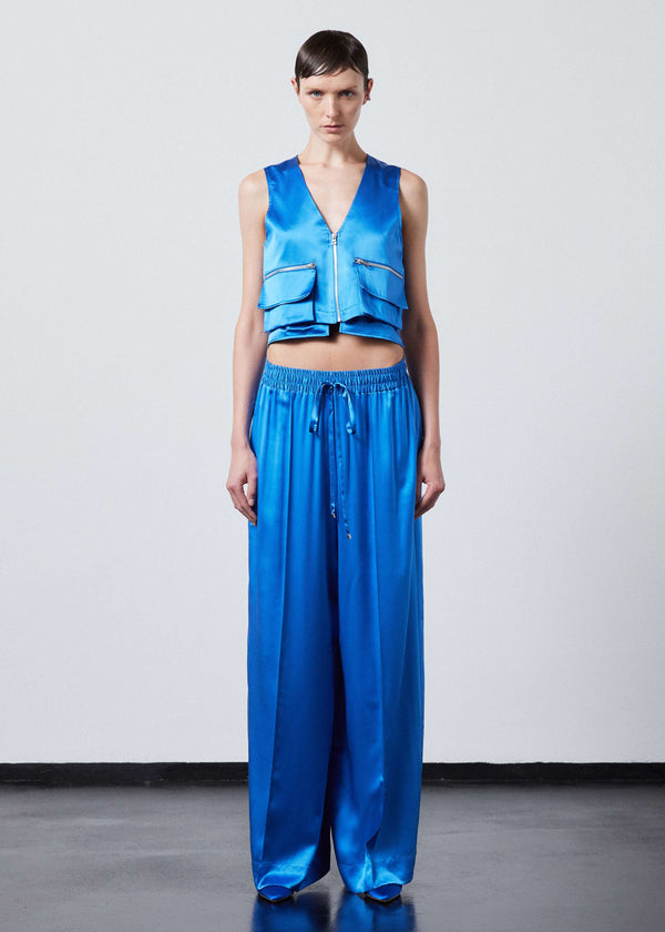 INTERNATIONAL CITIZEN.  Style: The Arcana Pant. Style has a relaxed fit with front pin-tucks and excessive volume eased into the waistband. Unisex Item. The pants are made of Italian organic silk in Azurite Blue. Spiritually Infused, Sustainable Luxury Fashion in Berlin.
