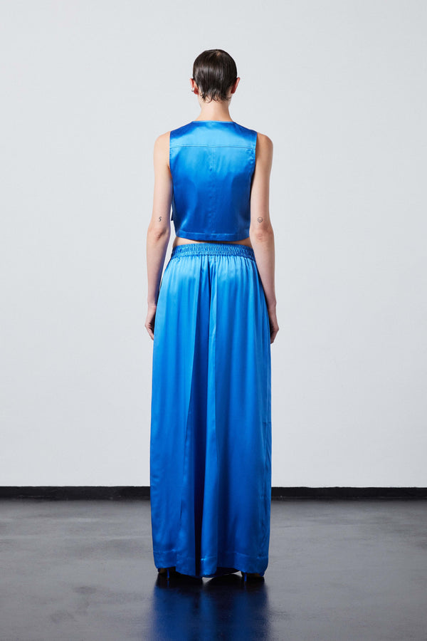 INTERNATIONAL CITIZEN.  Style: The Mini Zipper Vest. Made of Organic Silk, Azurite Blue. Spiritually Infused, Sustainable Luxury Fashion in Berlin. Full back body view.
