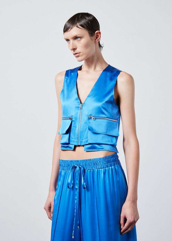 INTERNATIONAL CITIZEN.  Style: The Mini Zipper Vest has double pocket detailing with both a patch pocket and zipper welt with exposed pocket bags. It is fully lined with cotton poplin. Made of Organic Silk, Azurite Blue. Spiritually Infused, Sustainable Luxury Fashion in Berlin.
Front photo.