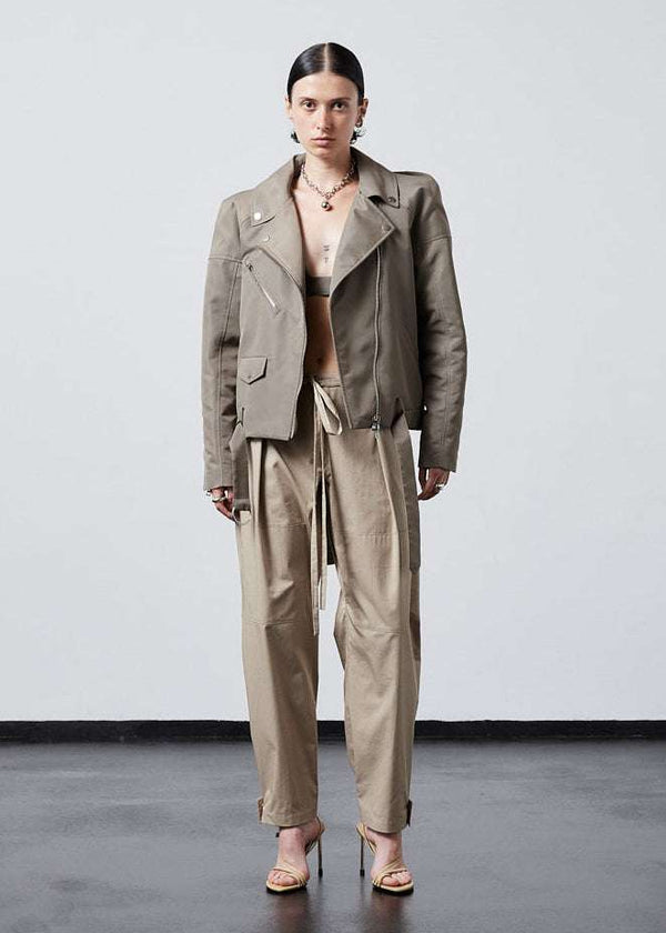 INTERNATIONAL CITIZEN.  Style: The M23 Moto Jacket has classic moto detailing and an innovative drape at the back shoulder creating a soft strength in the silhouette. Unisex Item. Full front view. Made of Italian post-consumer recycled Nylon, Dune. Spiritually Infused, Sustainable Luxury Fashion in Berlin.