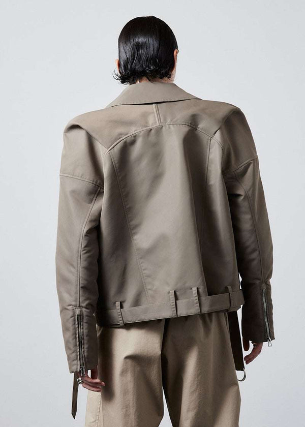 INTERNATIONAL CITIZEN.  Style: The M23 Moto Jacket has classic moto detailing and an innovative drape at the back shoulder creating a soft strength in the silhouette. Unisex Item. Back view. Made of Italian post-consumer recycled Nylon, Dune. Spiritually Infused, Sustainable Luxury Fashion in Berlin.