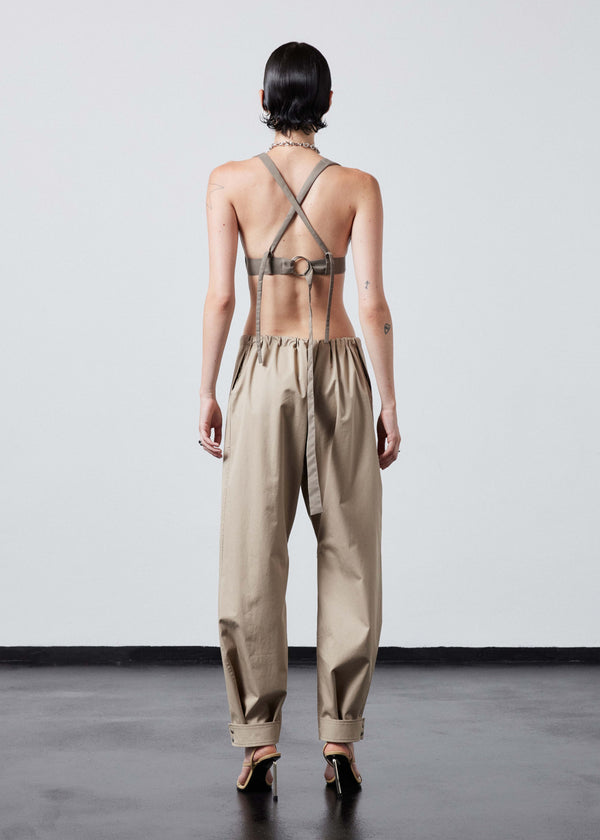 INTERNATIONAL CITIZEN.  Style: The Lunar Bralette features adjustable shoulder and chest straps with silver rings. Full body back view. Made of Italian post-consumer recycled Nylon, Dune. Spiritually Infused, Sustainable Luxury Fashion in Berlin.