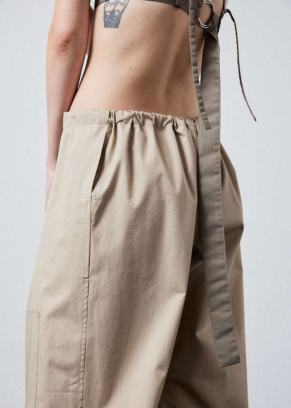 INTERNATIONAL CITIZEN.  Style: The JiuJitsu Pants are have a drawstring closer at the waist. Unisex item. Close up back waist. Made of Italian Organic Cotton Twill, Dune. Spiritually Infused, Sustainable Luxury Fashion in Berlin.