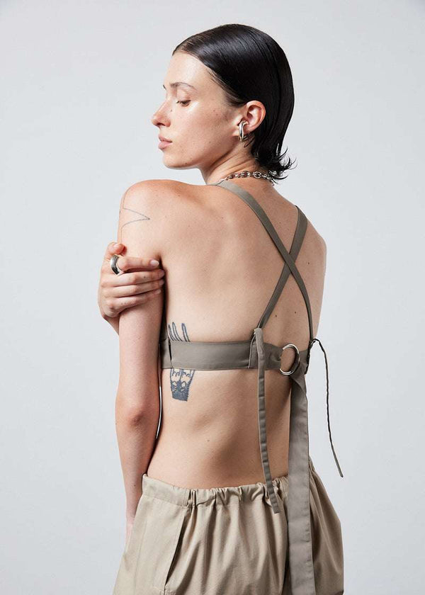 INTERNATIONAL CITIZEN.  Style: The Lunar Bralette features adjustable shoulder and chest straps with silver rings. Back view. Made of Italian post-consumer recycled Nylon, Dune. Spiritually Infused, Sustainable Luxury Fashion in Berlin.