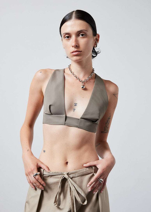 INTERNATIONAL CITIZEN.  Style: The Lunar Bralette features adjustable shoulder and chest straps with silver rings. Front photo. Made of Italian post-consumer recycled Nylon, Dune. Spiritually Infused, Sustainable Luxury Fashion in Berlin.