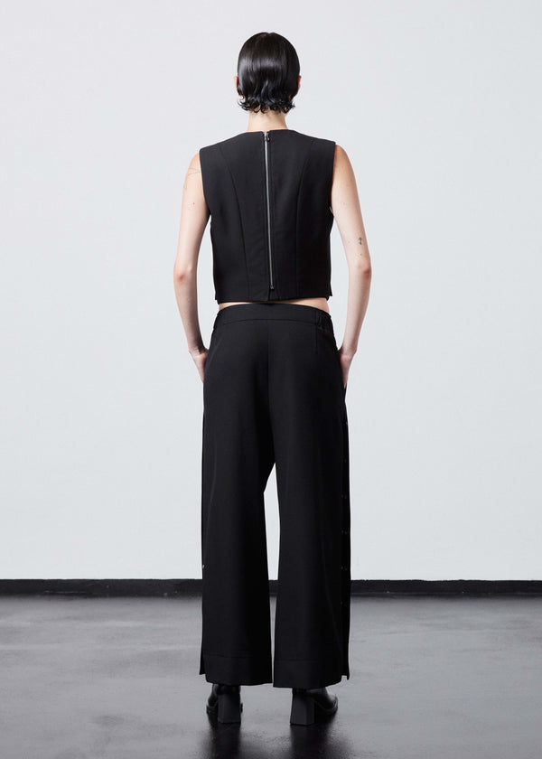 INTERNATIONAL CITIZEN.  Style: The Stitch Vest. Made of Italian Wool RWS, Obsidian Black. Spiritually Infused, Sustainable Luxury Fashion in Berlin. Full body back photo.