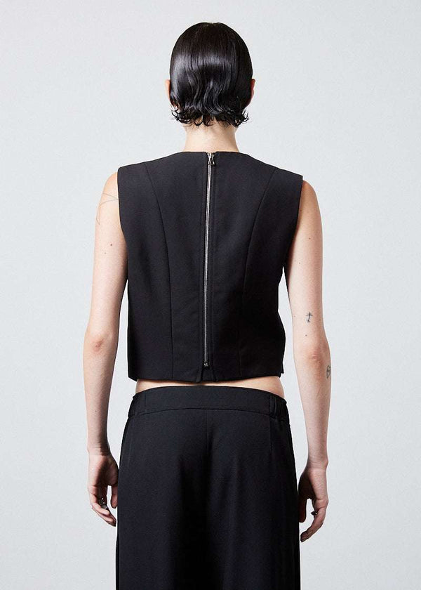 INTERNATIONAL CITIZEN.  Style: The Stitch Vest. The back has an exposed zipper for easy wearability and front flap welt pockets. Made of Italian Wool RWS, Obsidian Black. Spiritually Infused, Sustainable Luxury Fashion in Berlin. Back photo.