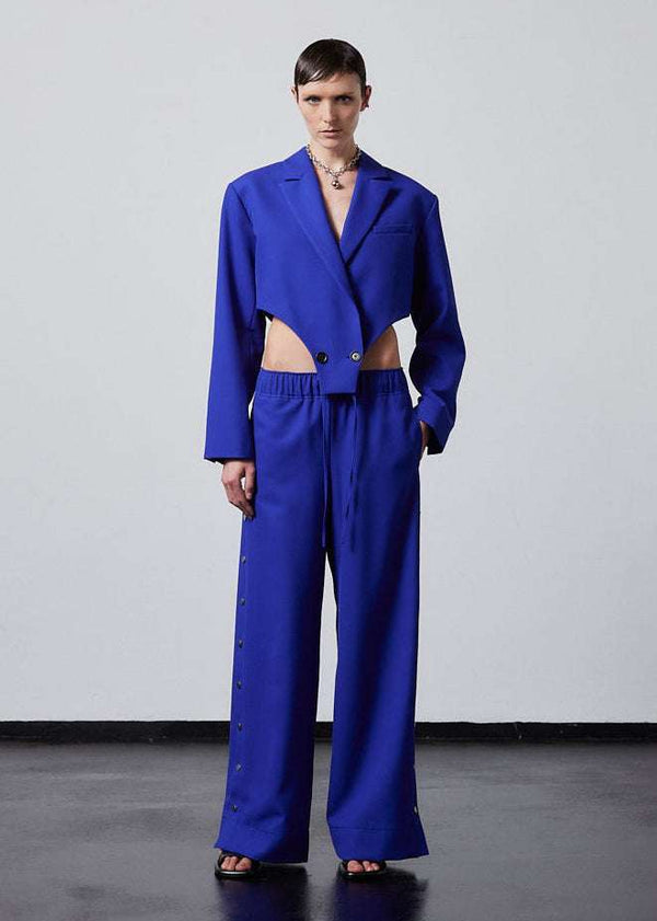 INTERNATIONAL CITIZEN.  Style: The French-Cut Jacket is oversized in the fit with a high french-cut hemline.Full body front photo. Unisex item. Made of Italian Wool, Lapis Lazuli blue. Spiritually Infused, Sustainable Luxury Fashion in Berlin.